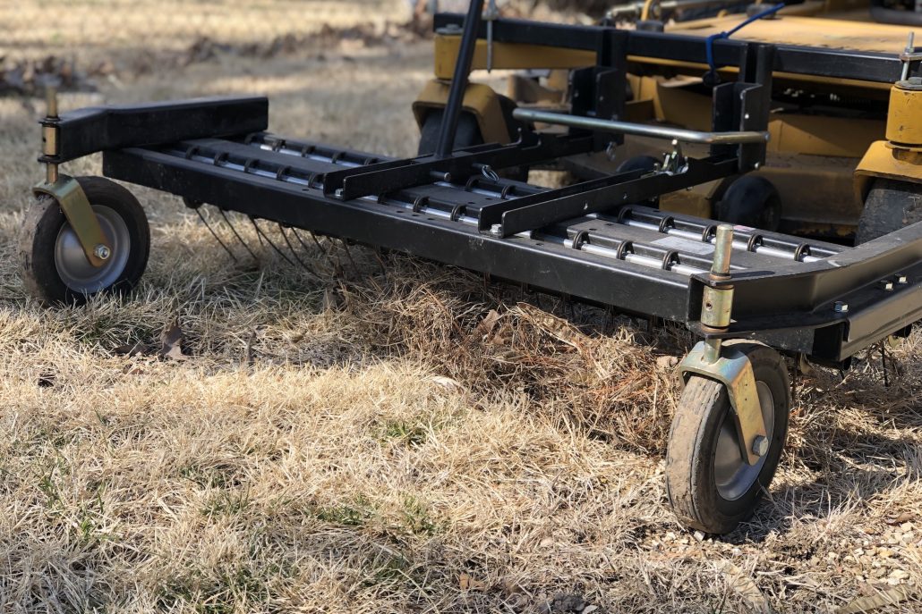 de-thatching equipment pulling up dead grass before seeding by PURE Lawn Management